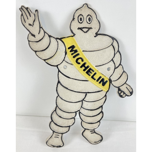 1332 - A painted cast iron wall plaque in the shape of the Michelin man. With holes for fixing. Approx. 35c... 