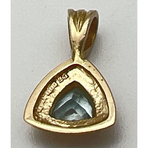 1145 - A modern design triangular shaped 9ct gold pendant set with a trilliant cut blue topaz.  Fixed bale ... 