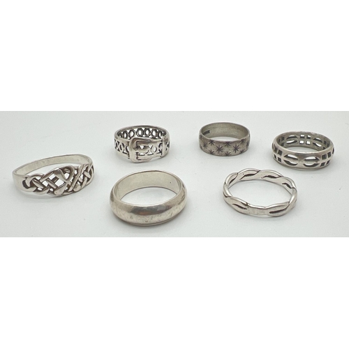 1146 - 6 silver and white metal band style rings. To include pierced work buckle ring, a twist design band ... 