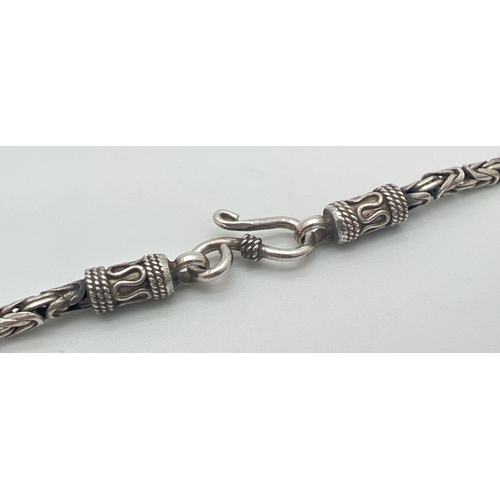 1150 - A 17 inch byzantine style silver chain neckalace with hook and eye clasp. Silver marks to clasp. Tot... 