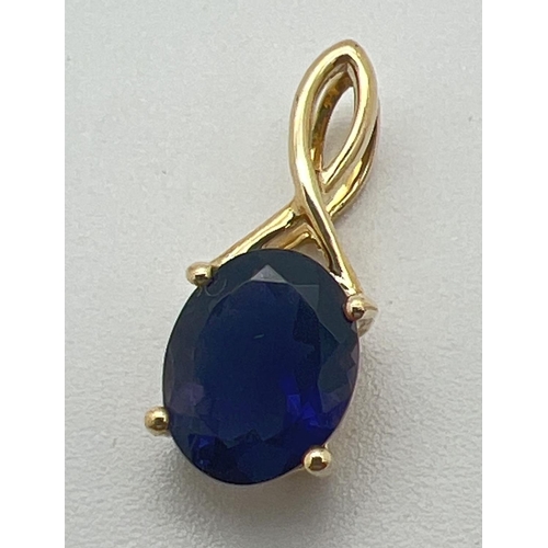 1152 - A 9ct gold oval cut Iolite set drop pendant with twist design fixed bale. Approx 1.75cm long, total ... 