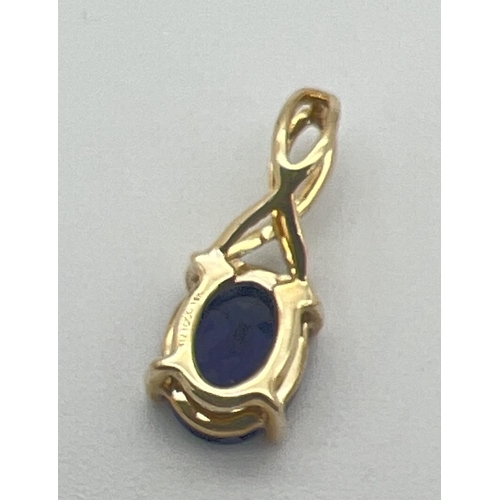 1152 - A 9ct gold oval cut Iolite set drop pendant with twist design fixed bale. Approx 1.75cm long, total ... 