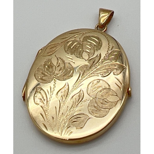 1155 - A vintage 9ct gold large oval locket with floral engraving to front. Glass panels to interior. Gold ... 