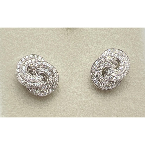 1160 - A pair of 18ct white gold Art Deco style twist knot design diamond earrings by Luke Stockley, London... 