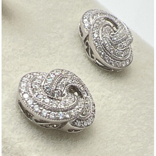 1160 - A pair of 18ct white gold Art Deco style twist knot design diamond earrings by Luke Stockley, London... 