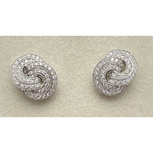 1160 - A pair of 18ct white gold Art Deco style twist knot design diamond earrings by Luke Stockley, London... 