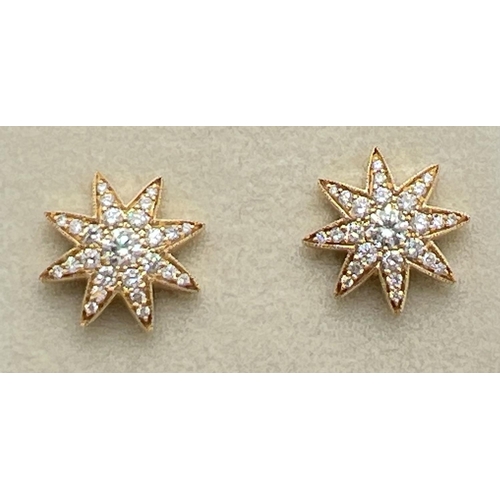 1175 - A pair of 18ct yellow gold diamond set star shaped stud earrings by Luke Stockley, London. Each earr... 