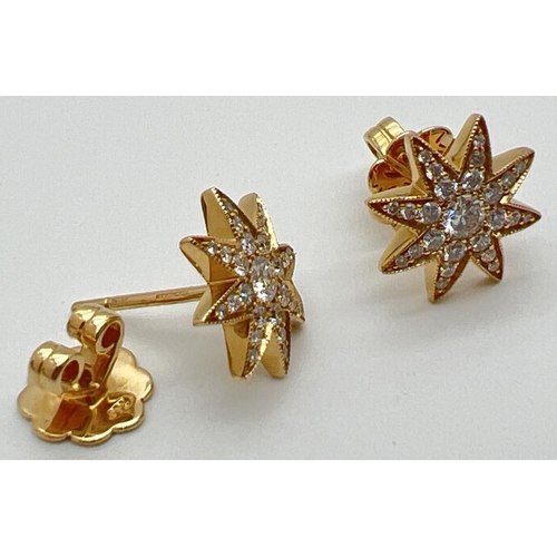 1175 - A pair of 18ct yellow gold diamond set star shaped stud earrings by Luke Stockley, London. Each earr... 