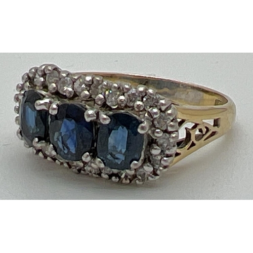 1177 - A 18ct gold sapphire and diamond trilogy dress ring. 3 central oval cut sapphires surrounded by 22 s... 