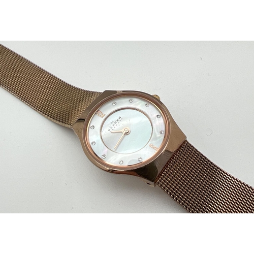 1191 - A boxed ladies Skagen 233XSRR wristwatch. Gold tone mesh bracelet strap and case with mother of pear... 