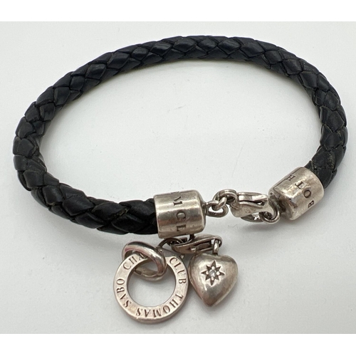 1193 - A black leather plaited bracelet with silver cap end and silver charms by Thomas Sabo. Charms includ... 