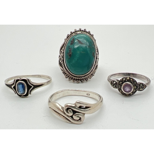 1179 - 4 silver dress rings. To include turquoise set, amethyst set and Iolite set. Silver marks to inside ... 