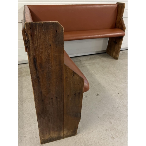 1391 - A corner bench seat as taken from a local pub, originally made from antique pews. Covered in tan col... 