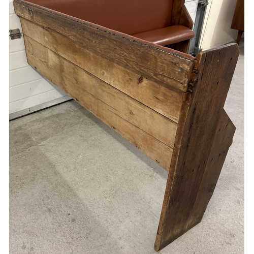 1391 - A corner bench seat as taken from a local pub, originally made from antique pews. Covered in tan col... 