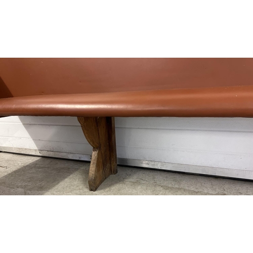 1392 - A corner bench seat as taken from a local pub, originally made from antique pews. Covered in tan col... 