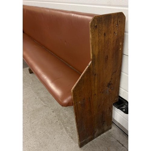 1392 - A corner bench seat as taken from a local pub, originally made from antique pews. Covered in tan col... 