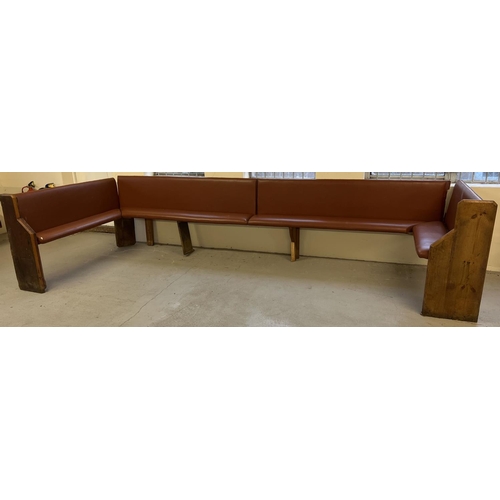 1393 - A large corner bench seat as taken from a local pub, originally made from antique pews. Covered in t... 