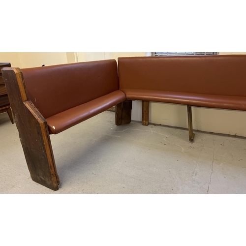 1393 - A large corner bench seat as taken from a local pub, originally made from antique pews. Covered in t... 