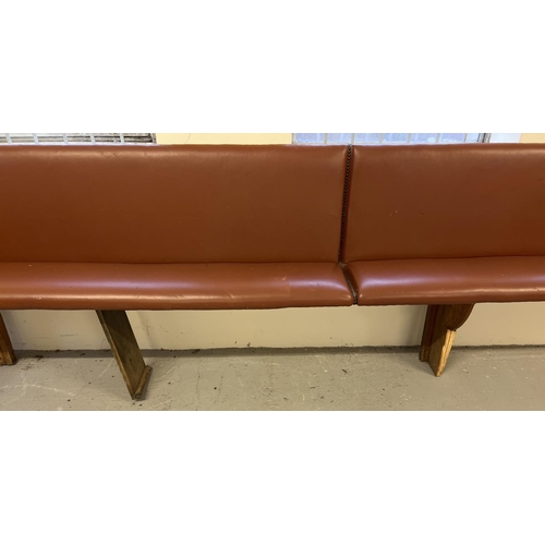 1393 - A large corner bench seat as taken from a local pub, originally made from antique pews. Covered in t... 