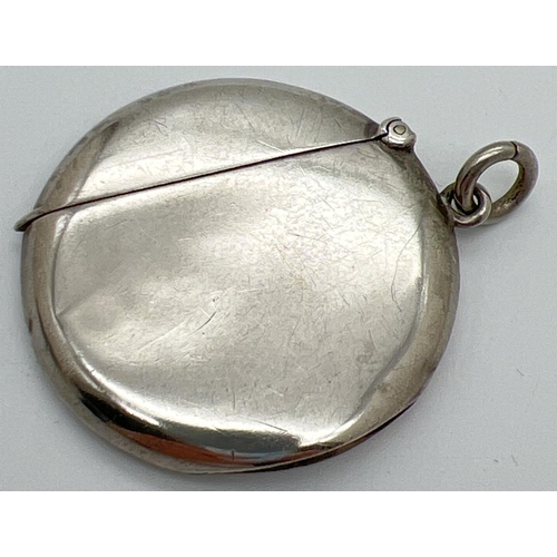 1209 - An Edwardian silver circular shaped vesta case with side hanging bale. Fully hallmarked to inside ri... 