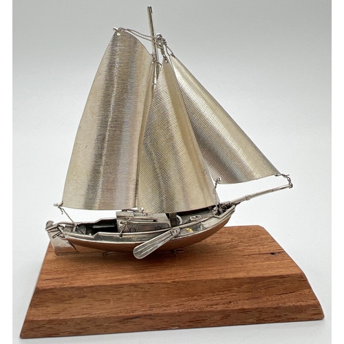 1217 - A vintage silver model of a sailing boat mounted on a wooden plinth. Very well detailed with matte f... 