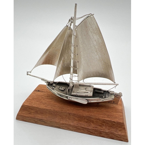 1217 - A vintage silver model of a sailing boat mounted on a wooden plinth. Very well detailed with matte f... 