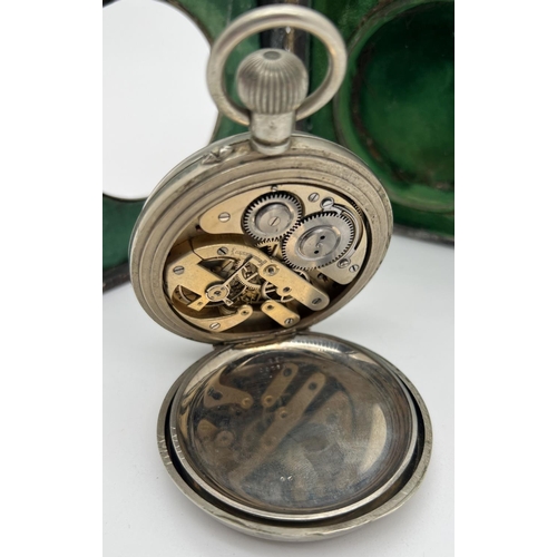 1218 - A late Victorian silver covered pocket watch stand with an Argentan Goliath pocket watch. Silver fro... 