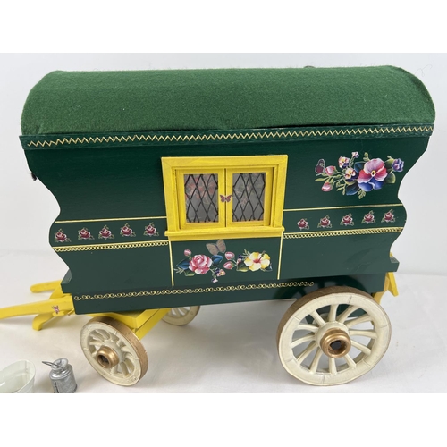 1355 - A painted wooden model of a Gypsy caravan with hand painted and sticker detail and green felt roof. ... 