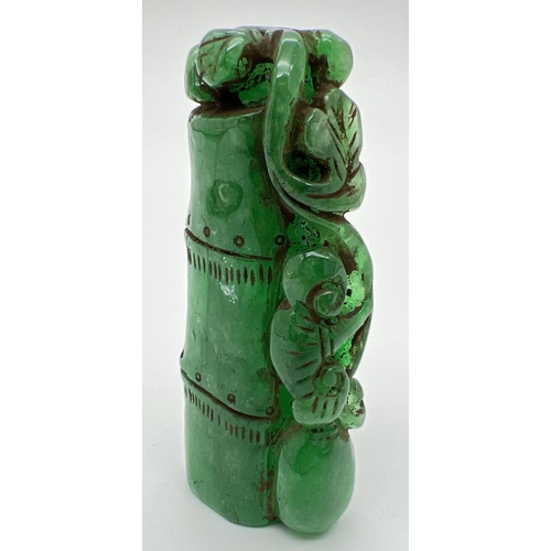 1292 - A carved piece of jade in the form of bamboo with foliate detail. Approx. 6.5cm long.