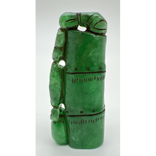 1292 - A carved piece of jade in the form of bamboo with foliate detail. Approx. 6.5cm long.