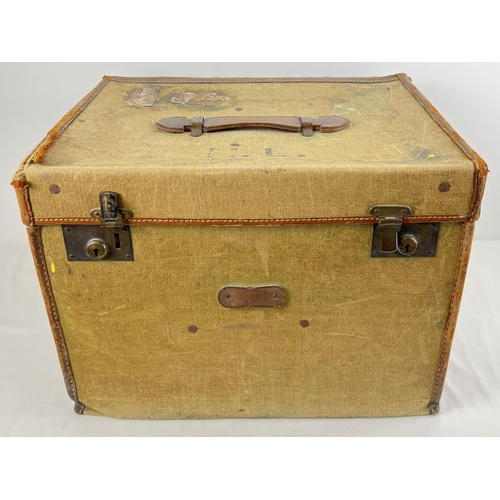 1363 - A vintage canvas and leather trim travelling trunk  with initials N.L. to top. Leather hadle to top ... 