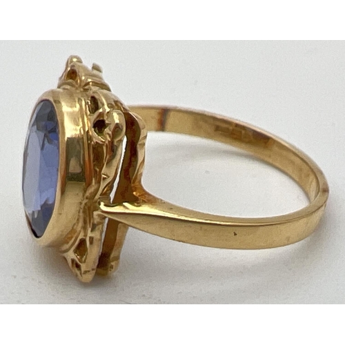 1 - An 18ct yellow gold and tanzanite ring with a decorative square shaped mount. Large oval cut tanzani... 