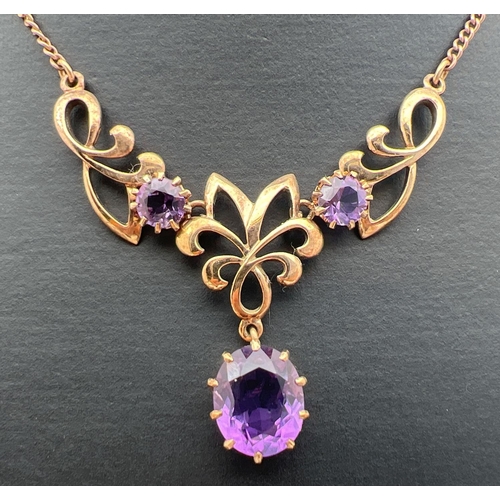 2 - A 9ct gold and amethyst fixed pendant necklace. A 3 sectional pendant set with 3 large amethyst ston... 