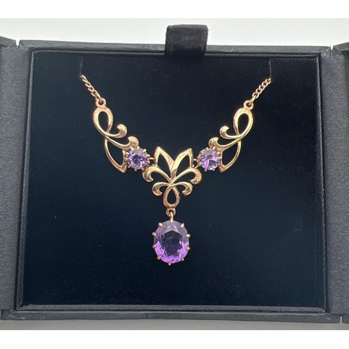 2 - A 9ct gold and amethyst fixed pendant necklace. A 3 sectional pendant set with 3 large amethyst ston... 