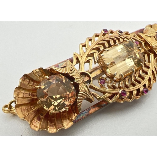 3 - A vintage 24ct yellow gold brooch set with 3 large yellow topaz stones and small ruby cabochons. A b... 