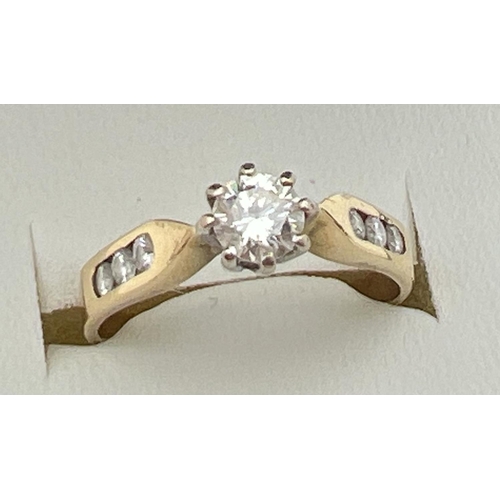 5 - An 18ct gold .33ct diamond solitaire ring with diamond channel set shoulders. Fully hallmarked insid... 