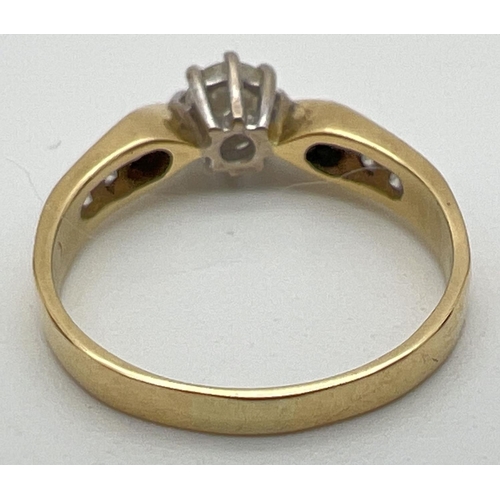 5 - An 18ct gold .33ct diamond solitaire ring with diamond channel set shoulders. Fully hallmarked insid... 