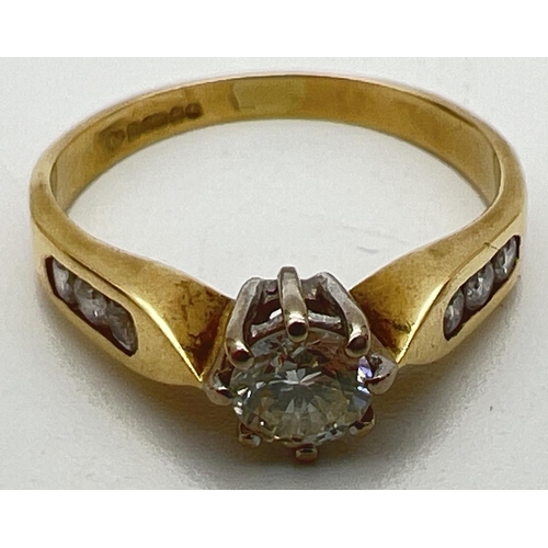 5 - An 18ct gold .33ct diamond solitaire ring with diamond channel set shoulders. Fully hallmarked insid... 