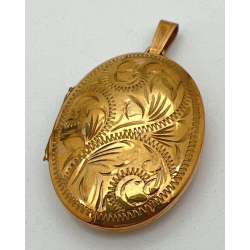 8 - A 9ct gold oval shaped locket with engraved scroll & foliate design to front. Fully hallmarked to re... 