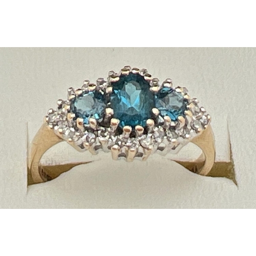 9 - A 9ct gold, London blue topaz and diamond ring in a diamond shaped halo setting. Central oval cut Lo... 