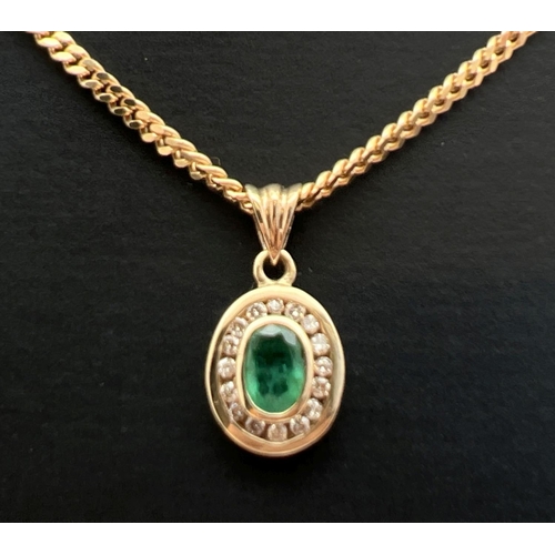 10 - A 9ct gold, emerald and diamond pendant on an 18