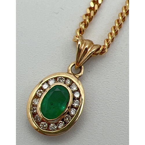 10 - A 9ct gold, emerald and diamond pendant on an 18