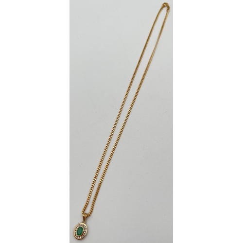 10 - A 9ct gold, emerald and diamond pendant on an 18