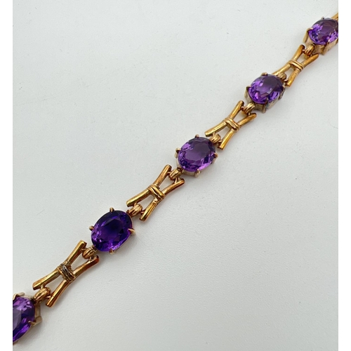 11 - A 9ct yellow gold and amethyst love and kisses style 13 link bracelet of alternating oval cut amethy... 