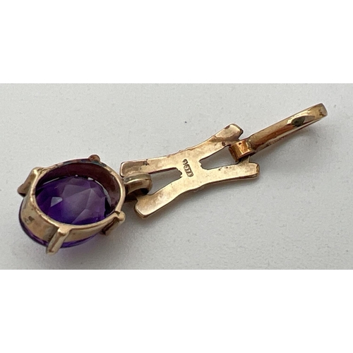 12 - A 9ct gold and amethyst love and kisses design pendant with oval cut stone (approx. 9mm x 7mm). Appr... 