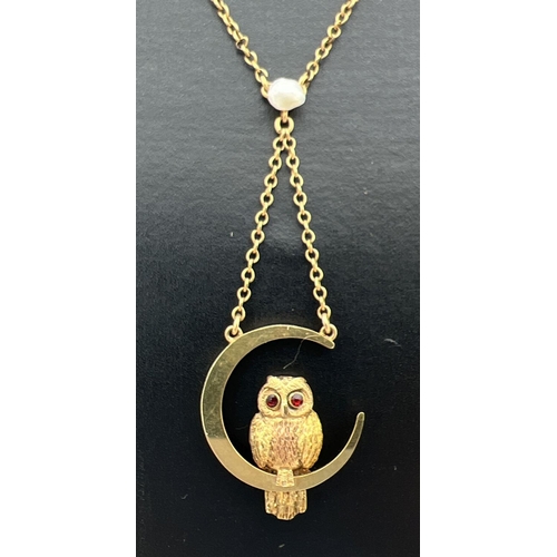 14 - A 9ct gold fixed pendant necklace featuring an owl sitting in a crescent moon. 16