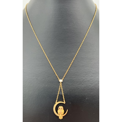 14 - A 9ct gold fixed pendant necklace featuring an owl sitting in a crescent moon. 16