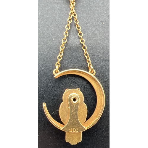 14 - A 9ct gold fixed pendant necklace featuring an owl sitting in a crescent moon. 16