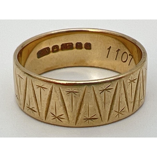 18 - A 9ct yellow gold band ring with channelled triangular design and engraved star shaped detail. Fully... 