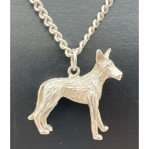 26 - A white metal pendant modelled as a dog an an 18